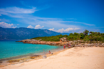 Fototapeta na wymiar People are swimming in Cleopatra beach. Cleopatra Beach is famous with sand in Marmaris.