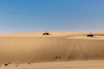 Fototapeta na wymiar Desert adventure, riding with a buggy over the dunes of the desert 