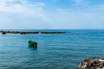 Monastery and boats frame the bay of San Vito. Polignano a mare