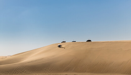Fototapeta na wymiar Desert adventure, riding with a buggy over the dunes of the desert 