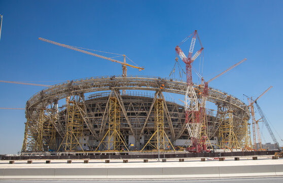 construction side of a football stadium with cranes and scaffoldings 