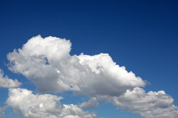 Naklejka na ściany i meble Summer typical clouds with deep blue sky