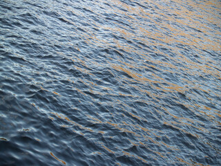 Waving surface of a river sunlit