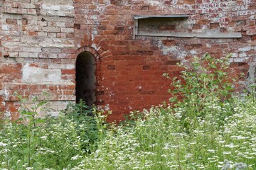 Window in the wall of a red brick building - Fortress Modlin in Poland