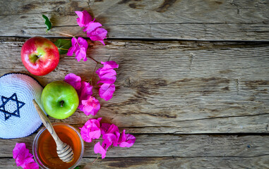 Honey and apple on wood deck  for Rosh Hashanah (Jewish New Year holiday) celebration.