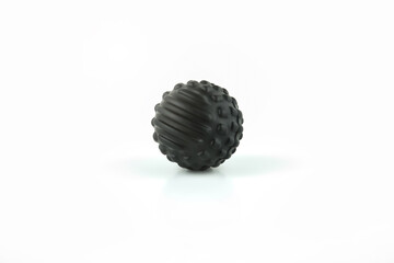 Black massage ball on white background isolated.
