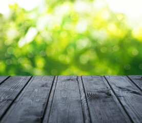 Empty wood table top on blur abstract green garden in the morning. Concept for  montage product display or design layout