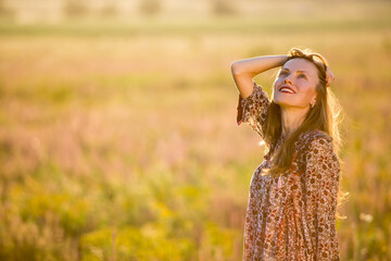 Beautiful natural woman with flying hair over natural background