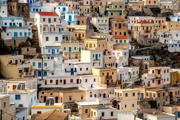 Naklejka premium GREECE, KARPATHOS - OCTOBER 17, 2019 -Traditional greek village of Olympos hidden in mountain range with typical houses