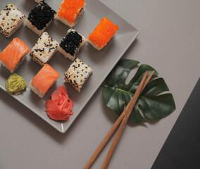 Japanese sushi rolls on dark background. 