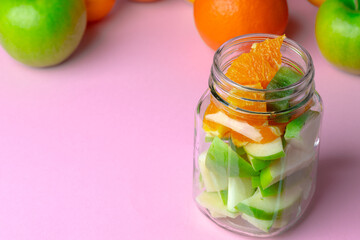 Glass bowl with fresh fruit pieces close up