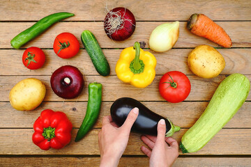 Assortment of fresh fruits and vegetables and holding hands