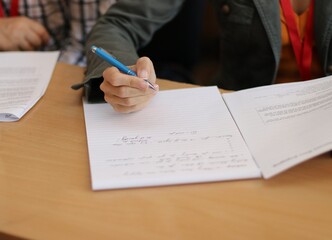 a woman taking notes on a piece of paper