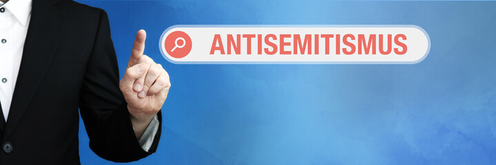 Antisemitismus. Anwalt zeigt mit Finger auf Suchfeld im Internet. Wort steht in der Suche. Konzept...