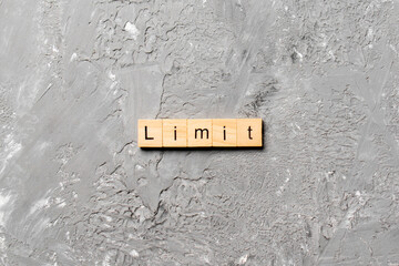 limit word written on wood block. limit text on table, concept