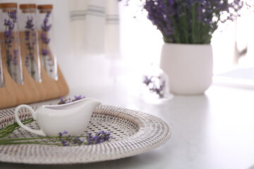 Beautiful lavender flowers and gravy boat on countertop indoors. Space for text