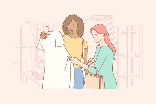Friendship, shopping, recreation, fashion, beauty concept. Young woman and african american girl friends customers choosing swapping trendy clothes at shop. Consumption and stuff exchage buying dress.