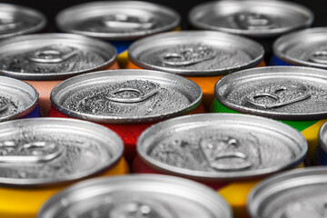 aluminum cans with carbonated water, energy drinks or beer. Background of aluminum cans