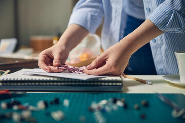 Caucasian female making a bow on paper certificate