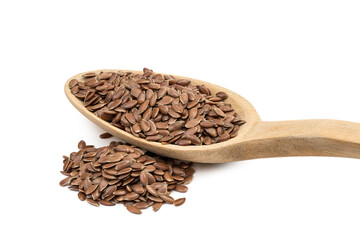 Close up of linseed or flax seeds on a wooden spoon with a pile next to it seen from the handle end and isolated on white background