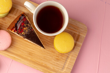 Piece of cheesecake with chocolate top and berries
