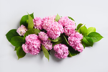 Fresh pink hydrangea flowers composition on grey background. Greeting card. Flowers delivery. Floral background. Banner. Top view.