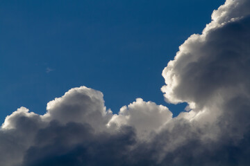 Naklejka na ściany i meble Dark beautiful cumulus clouds. Blue sky. Natural background.