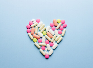 The heart is laid out of pills on a blue background. Health. Medicine. Pharmacy.