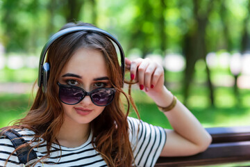 red haired girl is listening to music with headphones