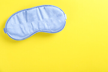 Top view shot of sleeping mask isolated on bright background. Close up, copy space, flat lay.