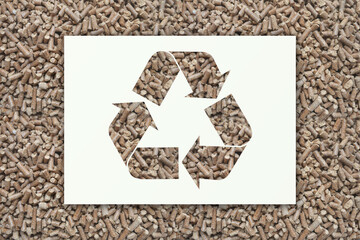 Recycle symbol on wood pellets background