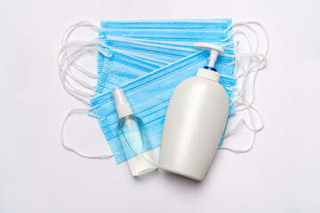 bottle of lotion, sanitizer or liquid soap and medical protective mask isolated on white background with clipping path