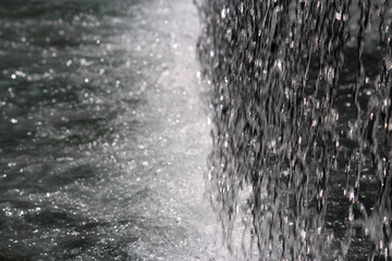 Water coming down from a water feature / fountain and aggressively hitting the pool of water below to create white water. Lloyd Rees Fountain or Matrix Fountain. Martin Place, Sydney