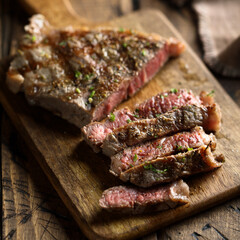 Roasted beef steak on a wooden desk