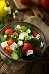 Traditional Greek salad with fresh spinach