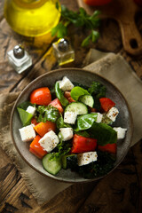 Traditional Greek salad with fresh spinach