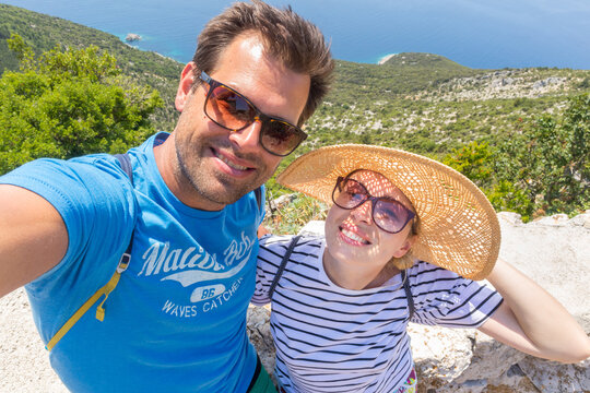 Beautiful, romantic caucasian couple taking selfie self portrait photo on summer vacations on Adriatic coast of Croatia.