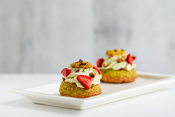 Mini cakes with cream and fruits. 