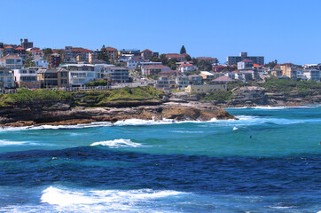 Fototapeta na wymiar Coastline with buildings cliffs and waves in summer. Eastern Suburbs Sydney