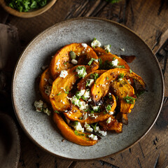 Healthy roasted pumpkin with cheese and herbs