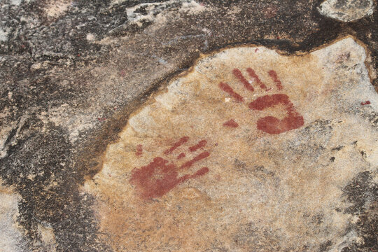 Tribal hand print on sandstone rocks by the ocean. Clovelly Beach, Sydney