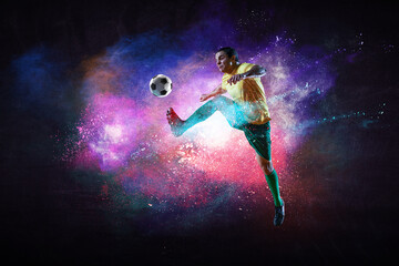 Plakat Boy playing soccer hitting the ball