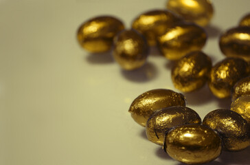 Golden chocolate easter eggs. Nest eggs. Savings and investment.