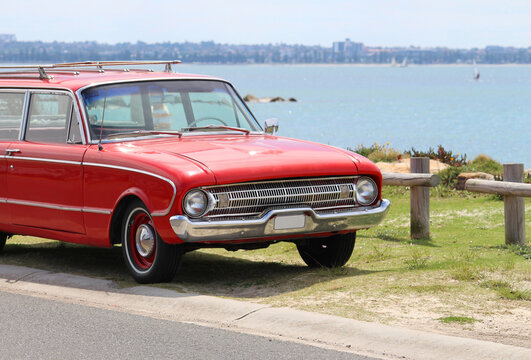 Vintage red car parked by the beach. Silver beach, Sydney. 