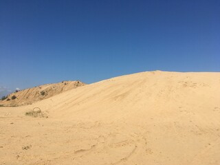 sand dunes against a blue cloudless sky