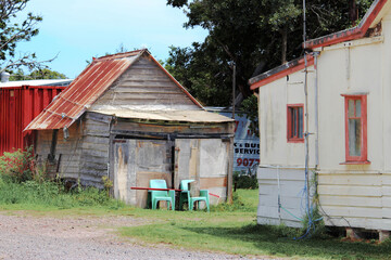 Old run down timber weather board structure / cabin and old fibro house. Silver beach, Sydney