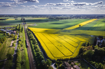 Drone view above railway tracks among fields in Rogow village, Lodz Province of Poland