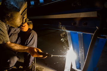 Close up of the welder that welds metal bar at the factory