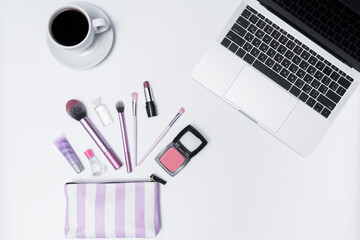 top view woman workspace with cosmetics, laptop and mug on white background