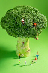 Miniature Runners jogging in a circle around a broccoli to train fitness and endurance for better...